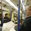 Guy reading newspaper in London