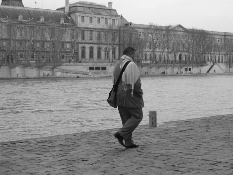 Paris City Photo - Black and White - Man walking on Les Quais de la Seine