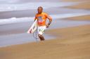 Kelly Slater running on the beach