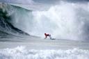 Kelly Slater surfing big swell